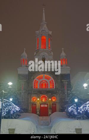Illuminated church Paroisse Saint-Sauveur in winter, Mont Saint-Sauveur, Quebec, Canada Stock Photo