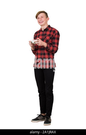 Joyful teenage boy playing video games isolated over white background. Excited guy stand all ears holding a joystick console looking attentive try to