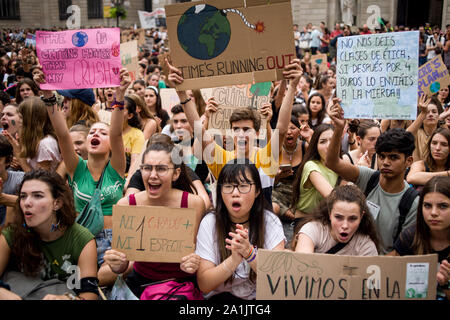 Students hold banners and shout slogans as they take part in a meeting in Barcelona during the strike for climate change as part of the Global Climate Strike. Stock Photo