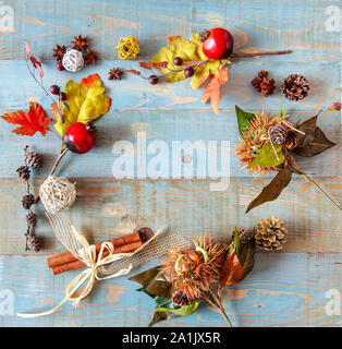 background with autumn leaves with heart shape laid on a dark blue background, also useful image for a Christmas style Stock Photo