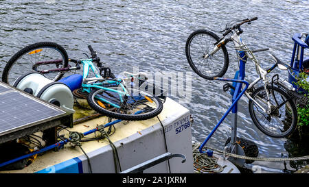 Bicycles or Push Bikes Tied to River Houseboats On The River Thames, London Stock Photo