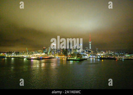 Night view of the skyline of Auckland, New Zealand, seen from a departing cruise ship. Stock Photo