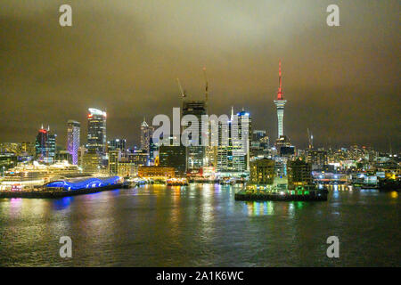 Night view of the skyline of Auckland, New Zealand, seen from a departing cruise ship. Stock Photo