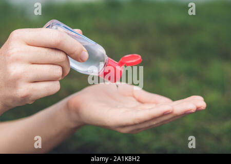 Women's hands using wash hand sanitizer gel Stock Photo