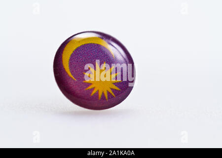 Malaysian flag symbl on thumbtack on white surface Stock Photo