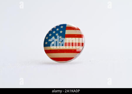 Usa flag symbol on metal thumbtack on white surface Stock Photo