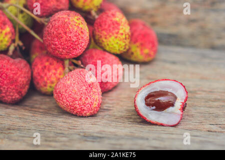 Fresh litchi fruit on an old wooden background Stock Photo