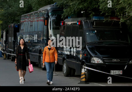 Beijing, China. 27th Sep, 2019. Chinese walk past a row of anti-riot police vehicles parked in downtown Beijing on Friday, September 27, 2019. The capital is on lockdown as preparations are being made for the October 1st 70th anniversary of the PRC, which will feature a military parade. Photo by Stephen Shaver/UPI Credit: UPI/Alamy Live News Stock Photo