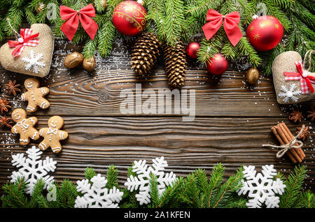Flat lay Christmas border background of twigs, baubles, gingerbread cookies and spices with copy-space Stock Photo