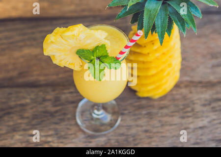 Pineapple and pineapple smoothies on an old wooden background Stock Photo