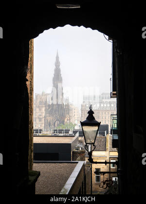 Hazy morning view of the Scott Monument through Advocates Close from the Royal Mile Edinburgh Scotland Stock Photo