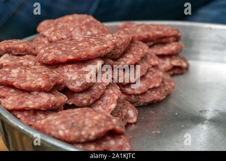 Turkish uncooked Meatballs or Kofta made with Minced Meat on Wooden Surface. Different kinds of turkish traditional meal Kofta on a light cutting. Stock Photo