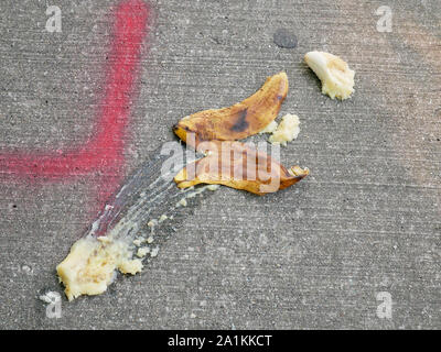 Banana and peel on sidewalk that somone evidently slipped on. Stock Photo