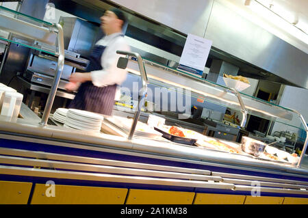 A chef preparing the food counter in a cafe. Stock Photo