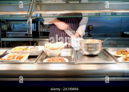 A chef preparing the food counter in a cafe. Stock Photo