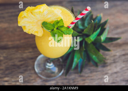 Pineapple and pineapple smoothies on an old wooden background Stock Photo