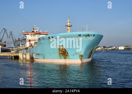 Products Tanker discharging at the Oil Terminal of lorient, France, with blue hull on sunny day. Horizontale view. Stock Photo