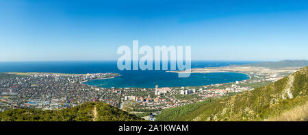 Wide aerial panorama of Gelendzhik resort city, Krasnodar region, Russia. View from hill of Caucasian mountains. Beautiful sea bay in frame. Stock Photo