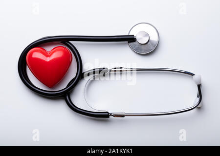 High Angle View Of Red Heart With Stethoscope Arranged Over Isolated On White Background Stock Photo