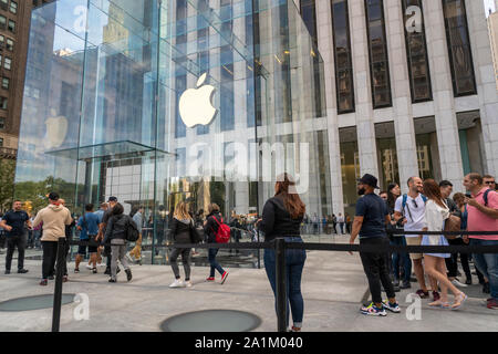 Customers enter the newly opened Apple store on Fifth Avenue in New York on opening day on Friday, September 20, 2019.  The new iPhones, the iPhone 11, iPhone 11 Pro and the iPhone 11 Max , anxiously awaited by drooling iPhone aficionados, sell between $699 and up to $1449 depending on the model and storage choices.  (© Richard B. Levine) Stock Photo