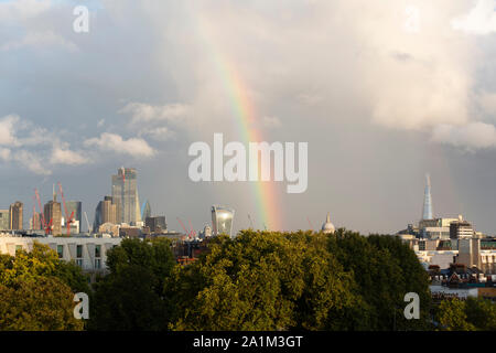 Weather, London UK. 27 September 2019. A rainbow rises above the City of London skyline near St Paul’s Cathedral after heavy rain across the Capital. Stock Photo