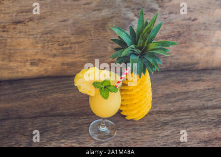 Pineapple and pineapple smoothies on an old wooden background Stock Photo