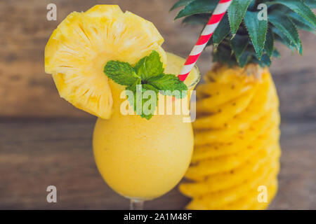 Pineapple and pineapple smoothies on an old wooden background Stock Photo
