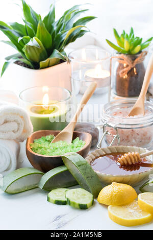 Close up display of a variety of natural skin care treatments including honey, aloe vera, cucumbers, lemons, coconut oil and himalayan salts. Stock Photo