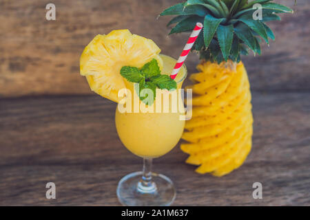 Pineapple and pineapple smoothies on an old wooden background Stock Photo