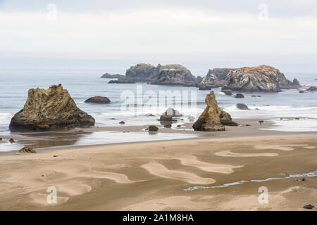 Sea stacks and sand patterns on Bandon Beach at low tide, Bandon, Oregon, USA Stock Photo