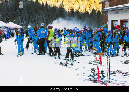 Bansko, Bulgaria - December, 12, 2015: Many young skiers preparing to ski in Bansko, Bulgaria Stock Photo