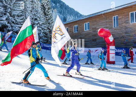 Bansko, Bulgaria - December, 12, 2015: Opening new ski season 2015-2016 in Bansko, Bulgaria. Skiers with Bulgarian flag at the slope Stock Photo