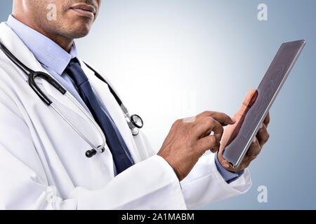 Male doctor using digital tablet. Stock Photo