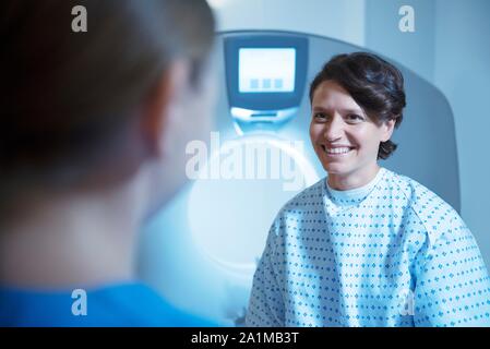 Radiographer preparing patient for computed tomography (CT) scan. Stock Photo