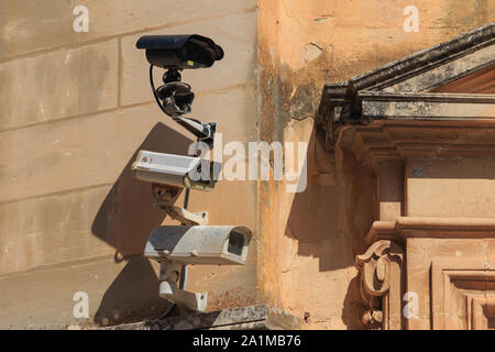 Three surveillance cameras on old wall in Mdina city, Malta Stock Photo