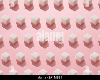 Sugar cubes on pink background. Stock Photo