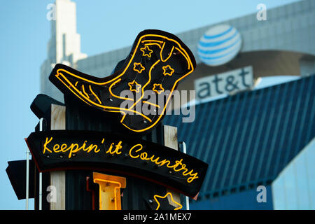 A country music bar's neon sign includes a cowboy boot in Nashville, Tennessee's entertainment district Stock Photo