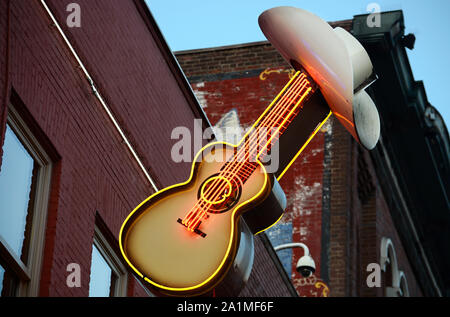 A neon sign in the shape of guitar and cowboy hat hangs over the entrance to the Stage, a popular bar and music venue in downtown Nashville, Tennessee Stock Photo