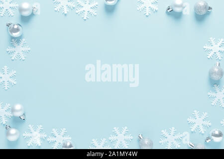 Christmas, New Year or Noel holiday festive winter greeting card, frame with decorations, balls and snowflakes on blue background, flat lay compositio Stock Photo