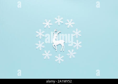 Christmas, New Year or Noel holiday festive winter greeting card, deer and snowflakes on blue background, flat lay composition, top view Stock Photo