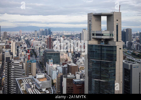 Osaka, Japan - September 22, 2019: Tall skyscraper stands above sprawling downtown Umeda district Stock Photo