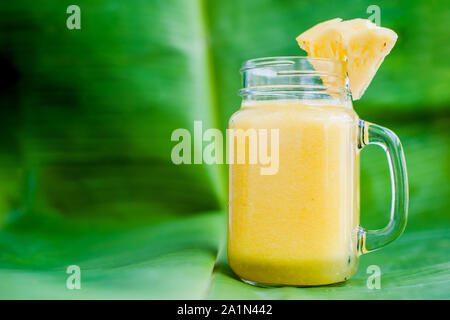 Pineapple cocktail with a slice of on banana leaf. Tropical concept Stock Photo
