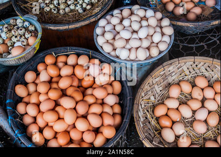 The eggs - chicken and quail in the wicker basket on the Vietnamese market Stock Photo