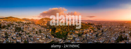 Aerial sunset panorama view of the Alhambra fortress and palace complex with surrounding medieval walls and towers in Granada Andalusia Spain Stock Photo