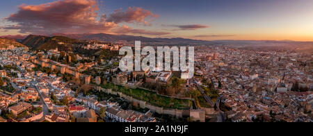 Aerial sunset panorama view of the Alhambra fortress and palace complex with surrounding medieval walls and towers in Granada Andalusia Spain Stock Photo