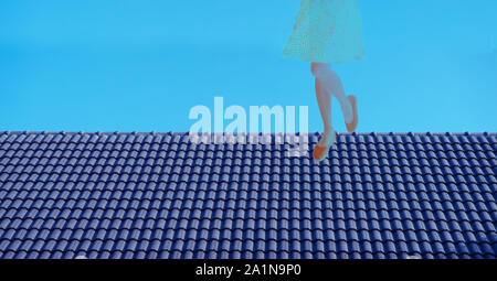 woman in polka dot dress standing on the dark blue ceramic roof top in creative freedom working oncept background Stock Photo