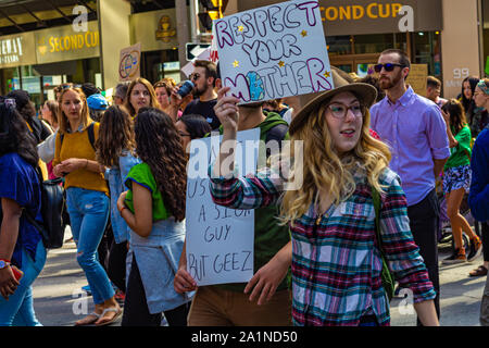 A young woman participating in the Climate Strike event in Ottawa holds a sign that reads "Respect Your Mother". Stock Photo