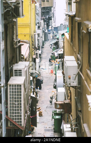 alley in Hong Kong among tall buildings. Stock Photo
