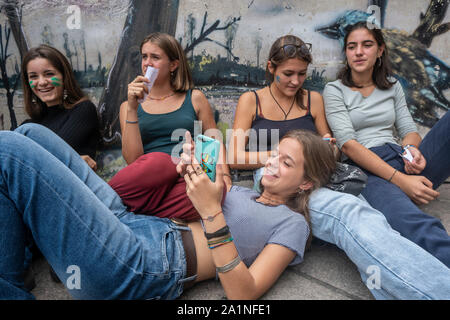 Milano, Italy. 27th Sep, 2019. Students resting on the ground during the protest.Students from High school and universities in Milan participated in the World Strike call of Friday for Future. The movement, started with the protest of a 16 year old Swedish activist Greta Thunberg, also spread in Italy, where the Ministry for Education recommended a day off for students. Credit: SOPA Images Limited/Alamy Live News Stock Photo