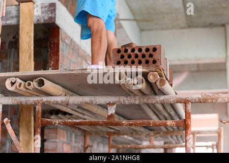 plasterer making up a brick wall Stock Photo